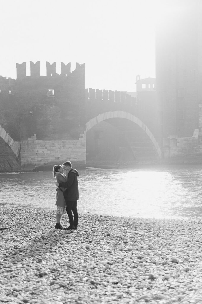 Backlit couple at Castelvecchio bridge Verona during winter