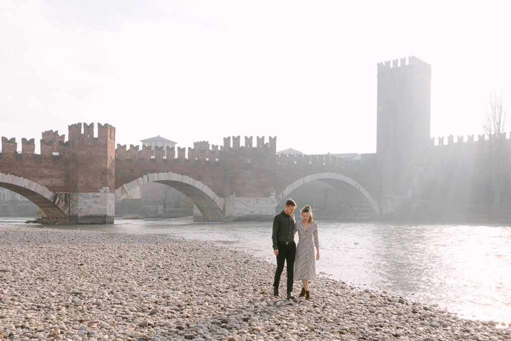 Final wide shot of couple at Castelvecchio bridge Verona