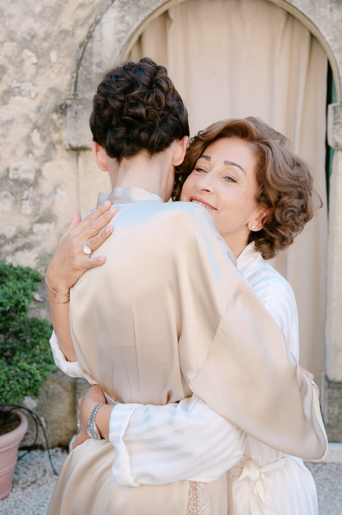 Abbraccio tra sposa e madre durante la preparazione del matrimonio a Villa Mosconi Bertani