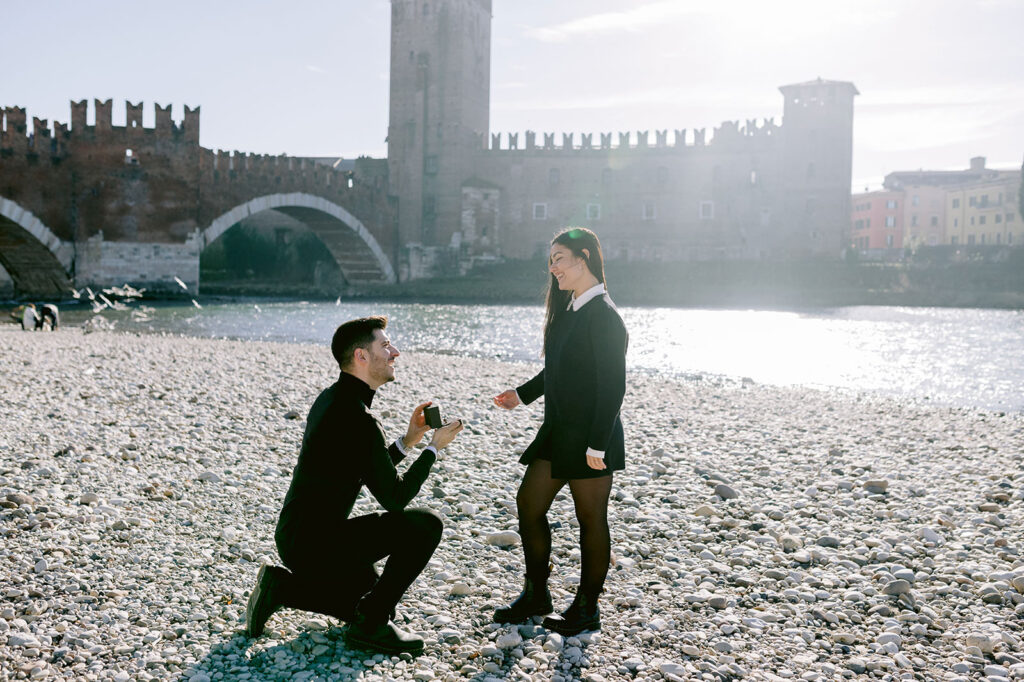 Verona marriage proposal photography near Ponte Pietra with a couple by the Adige river