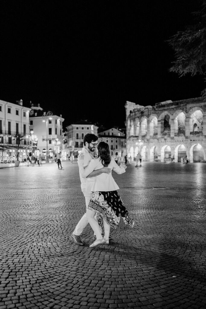 Verona engagement photography at night near the Arena with a couple dancing